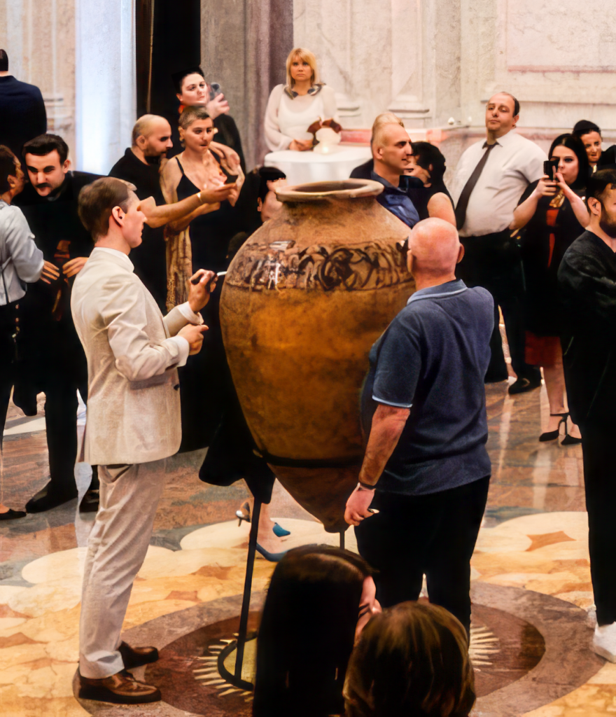 Sergo Tbileli and Jacob Fiege painting Qvevri at the event